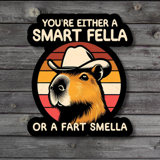 Capybara with the humorous text 'Are You A Smart Fella Or Fart Smella' on a sticker